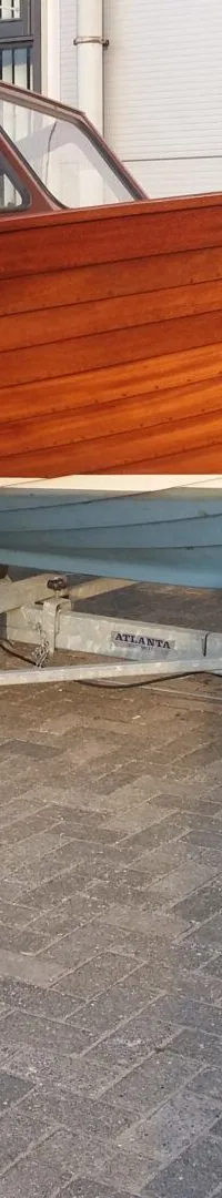 Een houten boot met de naam "The Boat" en registratienummer "96-95-YP" staat op een trailer. — Flying Finn 19.60