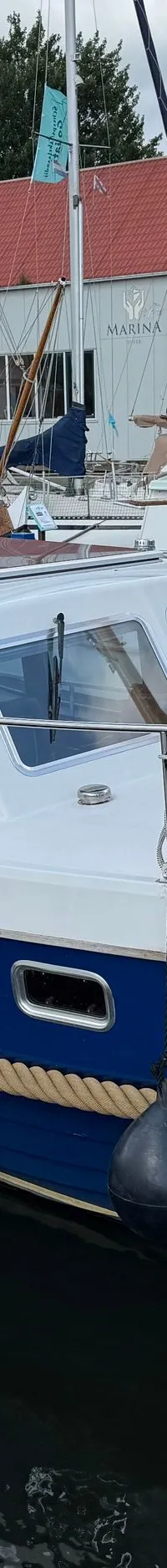Een blauw-witte motorboot met de naam "Balance" ligt afgemeerd in een haven. — Drammer 8.20 Classic