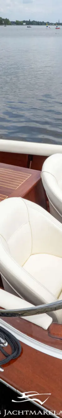 Een houten boot met twee witte stoelen en een tafel, afgemeerd aan een houten steiger. — Divank Divank Uscire 635